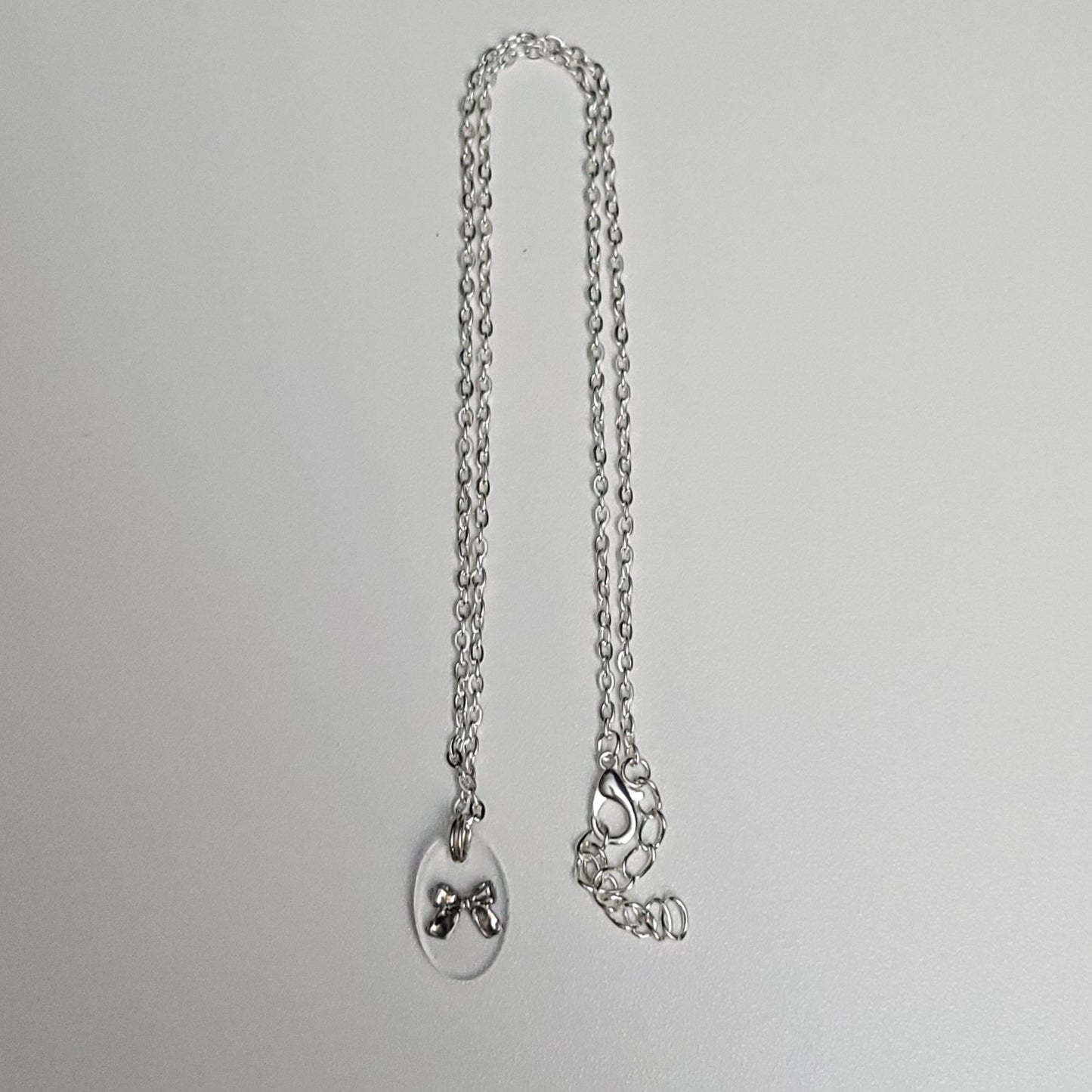 Bow resin necklace - test sample - Maker's One Takers