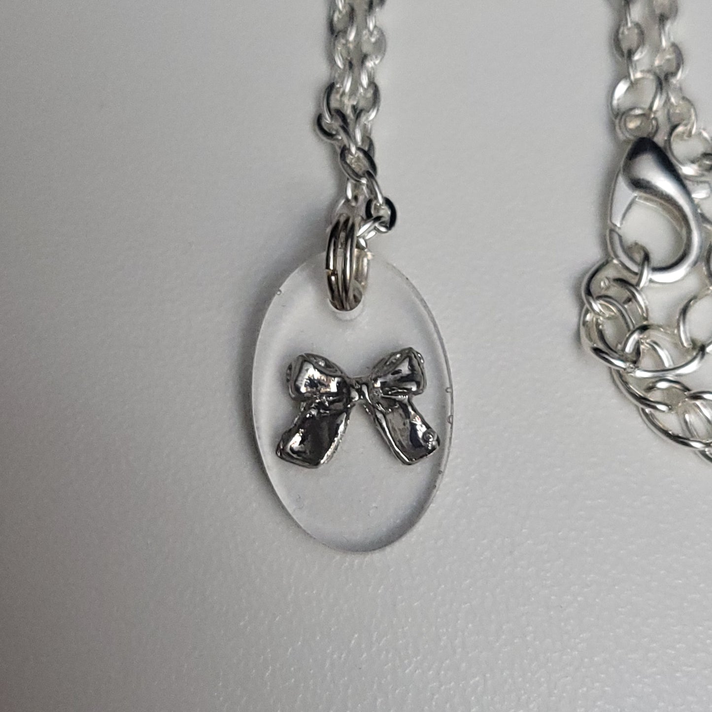Bow resin necklace - test sample - Maker's One Takers